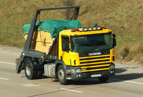 a lorry being used to transport a midi skip